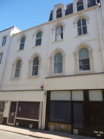 ... above nondescript shop premises below.