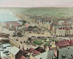 A tinted 19th century slide showing a busy scene