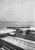 A train passes across a snow-covered St Aubin's Bay