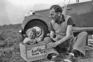 Mike in a fruit box with his father in 1951