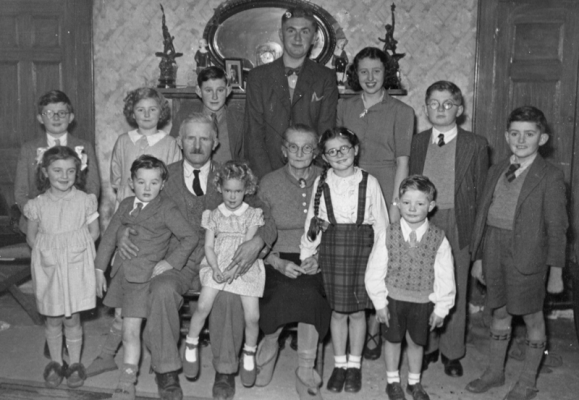 Alfred Edward Surcouf and Louisa Jane, nee Le Marchand, and nearly all their grandchildren. Alfred wasf the founder of A E Surcouf and Sons trading as Weston Dairy, known as Surcouf's Dairy. Back row: Brian, 1940; Tess, 1939; Ben, 1936; Ken, 1932; Ena, 1934; Rodney, 1938; Clifford, 1940. Front row: Patsy, 1943; Peter, 1945; Alfred, 1884; Jenny, 1947; Louisa, 1887; Val, 1941; Graham, 1945. Missing: Doris, 1930; Morris, 1933