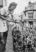 Laura Bisson hands out flags on Liberation Day, 9 May 1945