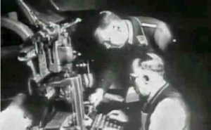 A linotype operator supervised by a German during the Occupation