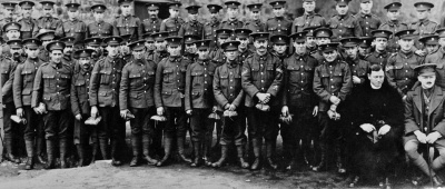 More 3rd (Town) Battalion members pose in February 1915 with members of the YMCA send-off committee after receiving their send-off parcels at the temporary barracks established in the Canning Factory at Grève d’Azette. They would leave for training in southern Ireland a few days later.
