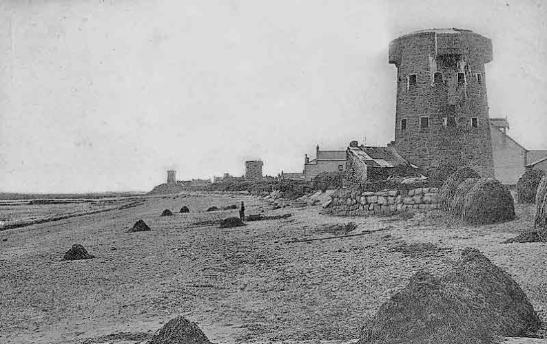A row of towers in Grouville Bay
