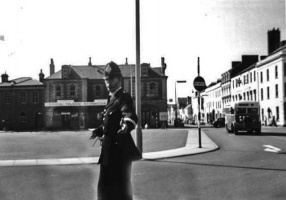 A policeman directing traffic at the Weighbridge