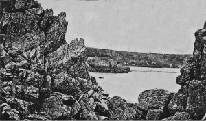 An unusual view through Beauport rocks with St Brelade's Bay in the distance