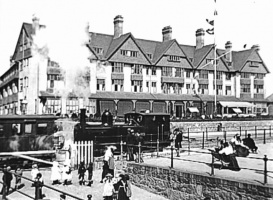 A train stops at the station opposite the hotel