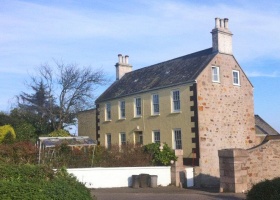 The south-west corner, showing how the land slopes down into the courtyard where the eastern face of the house has an extra storey
