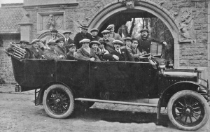 A charabanc outing stops outside the entrance to the manor